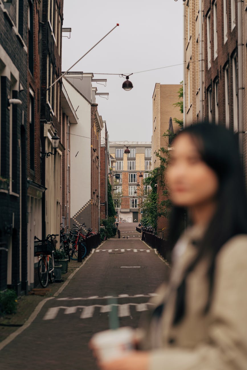 brunette woman in blur in a narrow street