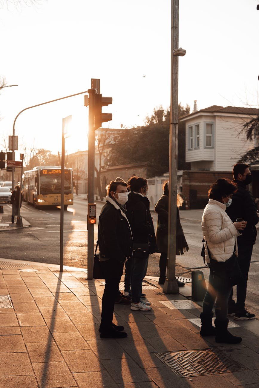 people standing on crosswalk in city street